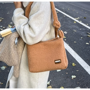 Close-up of caramel fleece crossbody bag showing thick texture and metal ring detail