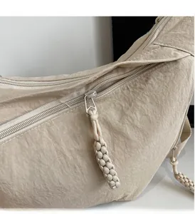 Detailed macro view of the smooth zipper and durable woven cord puller on the beige canvas bag