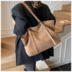 Close-up of khaki tote bag with adjustable metal buckle and premium matte texture