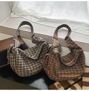Detail of tweed checkered tote bags with wide straps and vintage embroidery
