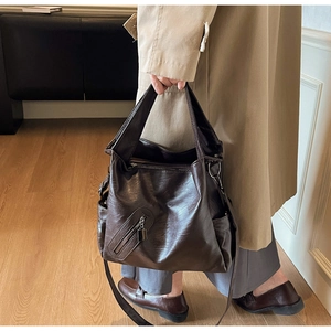 Deep brown large capacity tote bag with wide straps and textured leather surface