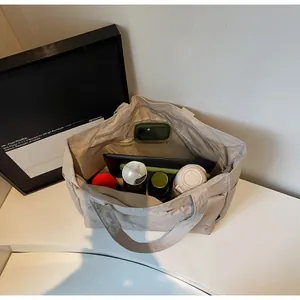 Top view of a spacious beige nylon tote bag showing its large interior capacity and texture