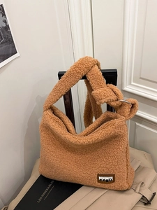 Caramel fluffy faux fur shoulder bag with knotted strap and minimalist brand label