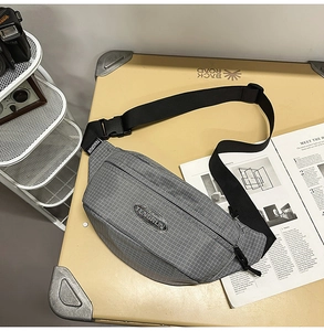Detail of grey checkered crossbody waist bag with adjustable strap and durable buckle
