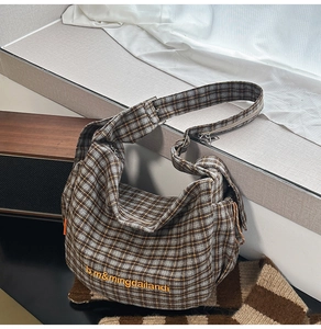 Close-up of retro plaid canvas hobo bag with high-quality woven texture and embroidery