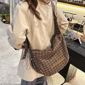 Detail view of the retro checkered canvas tote bag with adjustable shoulder strap