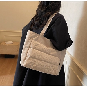 Close-up of quilted tote bag with pleated fabric texture and large capacity design