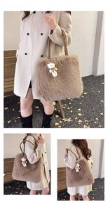Detail of khaki faux fur tote bag with woven brown handles and cute white bear charm