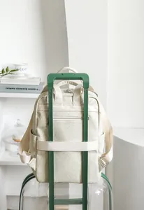 Detail view of the luggage trolley sleeve on a stylish off-white business backpack