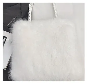 Detail of soft white faux fur texture and woven rope handle on a plush shoulder bag