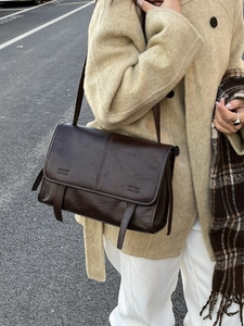 Retro dark brown textured leather shoulder bag for women styled with a beige winter coat