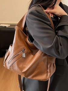 Caramel brown large hobo shoulder bag with front zipper and wide strap detail