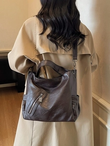 Brown vintage faux leather tote bag with side pockets and a stylish zipper detail