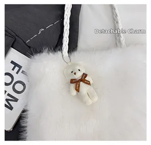 Close-up of white fluffy tote bag featuring a removable teddy bear charm with Love ribbon