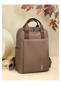 Detail of brown twill textured backpack with premium metal zippers and woven fabric