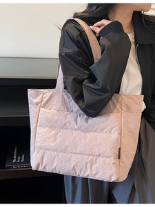 Light pink quilted nylon tote bag with puffer design and wide shoulder strap for women