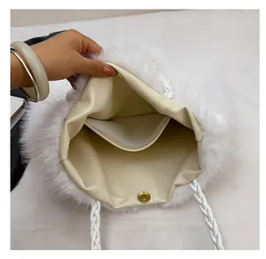 Detail of the white faux fur tote bag showing the magnetic closure and beige lining