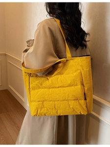 Minimalist bright yellow quilted puffer tote bag with wide shoulder strap for women