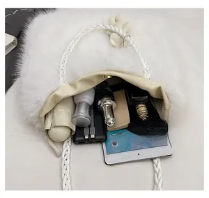 Top view of large capacity white fuzzy tote bag showing interior with daily essentials