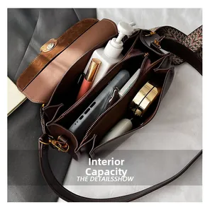Detail of vintage crossbody bag showing internal compartments and large storage capacity