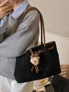 Retro black tote bag with brown leather handles and cute bear charm for daily commute