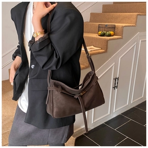 Close-up of retro large capacity crossbody bag in matte coffee suede with metal buckle