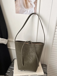 Olive green bucket bag in matte leather with decorative drawstring for daily commuting