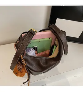 Interior view of brown leather hobo bag showing large storage capacity for tablet and items