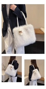 Detail of white faux fur tote bag featuring braided handles and a cute bear charm pendant