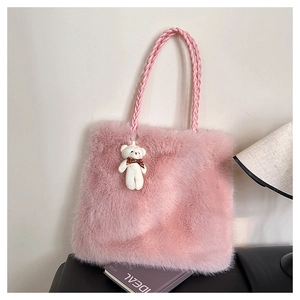 Close-up of pink faux fur tote bag with woven handles and a cute white bear pendant