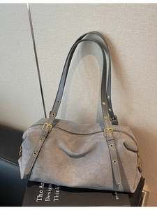 Grey suede minimalist shoulder bag with vintage gold hardware and adjustable straps
