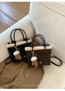 Detail of winter bucket bag with faux shearling trim and decorative rope handle knots