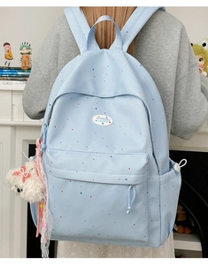Light blue polka dot backpack for girls with cute bear charm and woven label detail