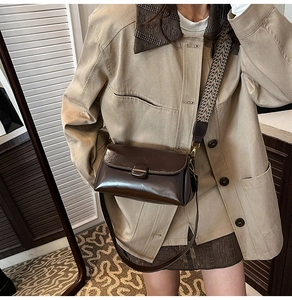 Detail view of vintage dark brown crossbody bag with two interchangeable stylish shoulder straps
