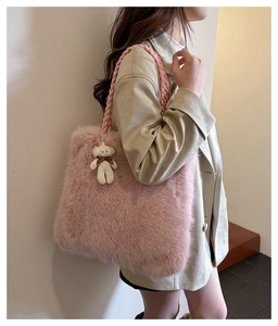 Detailed shot of pink fuzzy faux fur tote bag with braided handles and bear pendant