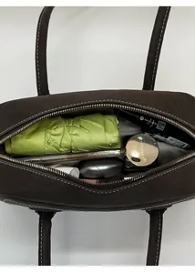 Top view of spacious dark brown leather bag showing interior storage for daily items