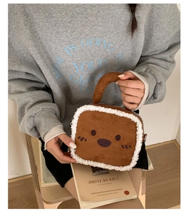 Close-up of toast-shaped plush handbag with cute embroidery and soft sherpa trim