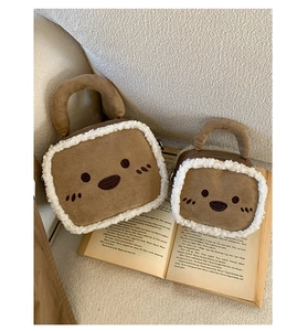 Detail of cute bear cartoon handbags featuring fluffy white faux fur trim and brown suede