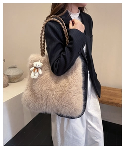 Close-up of fluffy cream plush tote bag featuring dark brown woven rope handles and a bear charm