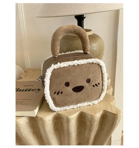 Close-up of toast-shaped plush handbag with cute embroidery and fuzzy sheepskin trim
