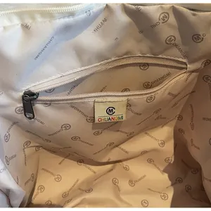 Detail shot of the spacious inner compartment with a secure zipper pocket for tote bag