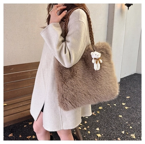 Brown fluffy faux fur tote bag with a woven handle and cute white bear keychain detail