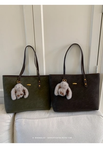 Detail of retro faux leather tote bags in olive green and coffee with cute bunny charm