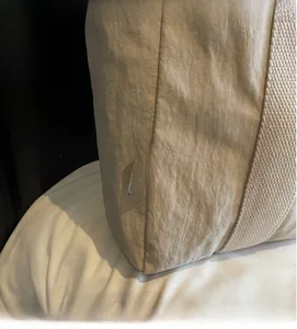 Close-up of beige textured fabric tote bag showing the Chuangmi brand label detail