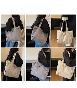 Detail view of large grey-purple and beige tote bags showing material and zippers