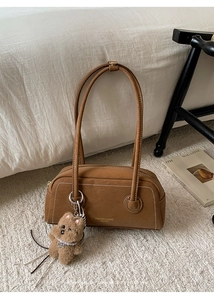Brown retro leather underarm bag with white stitching and plush bear charm detail