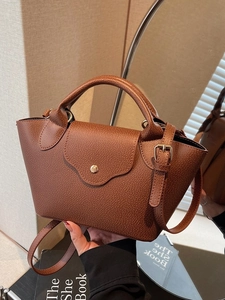 Brown pebble leather crossbody bag with top handle and adjustable strap for women