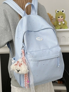 Light blue polka dot backpack for girls with plush charms and decorative bows