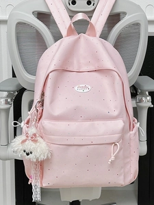 Pink polka dot backpack for school with a cute plush puppy charm on the zipper