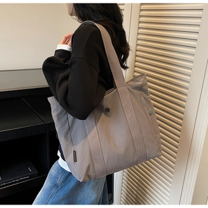 Detailed view of the dusty purple tote bag showing durable nylon fabric and woven straps